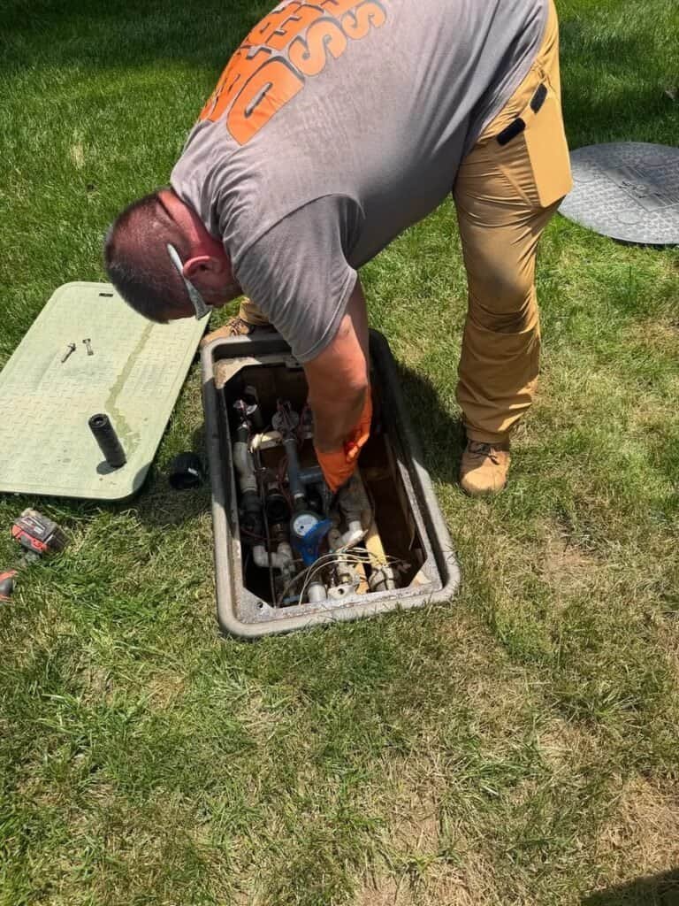 Dahl Septic technician checking an engineered septic system manifold box